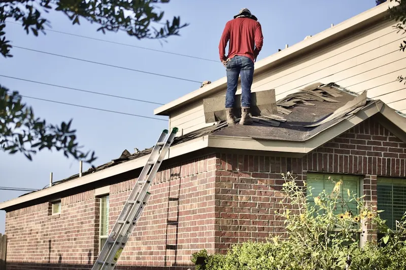 Professional roofer working on a residential roof in Powder House